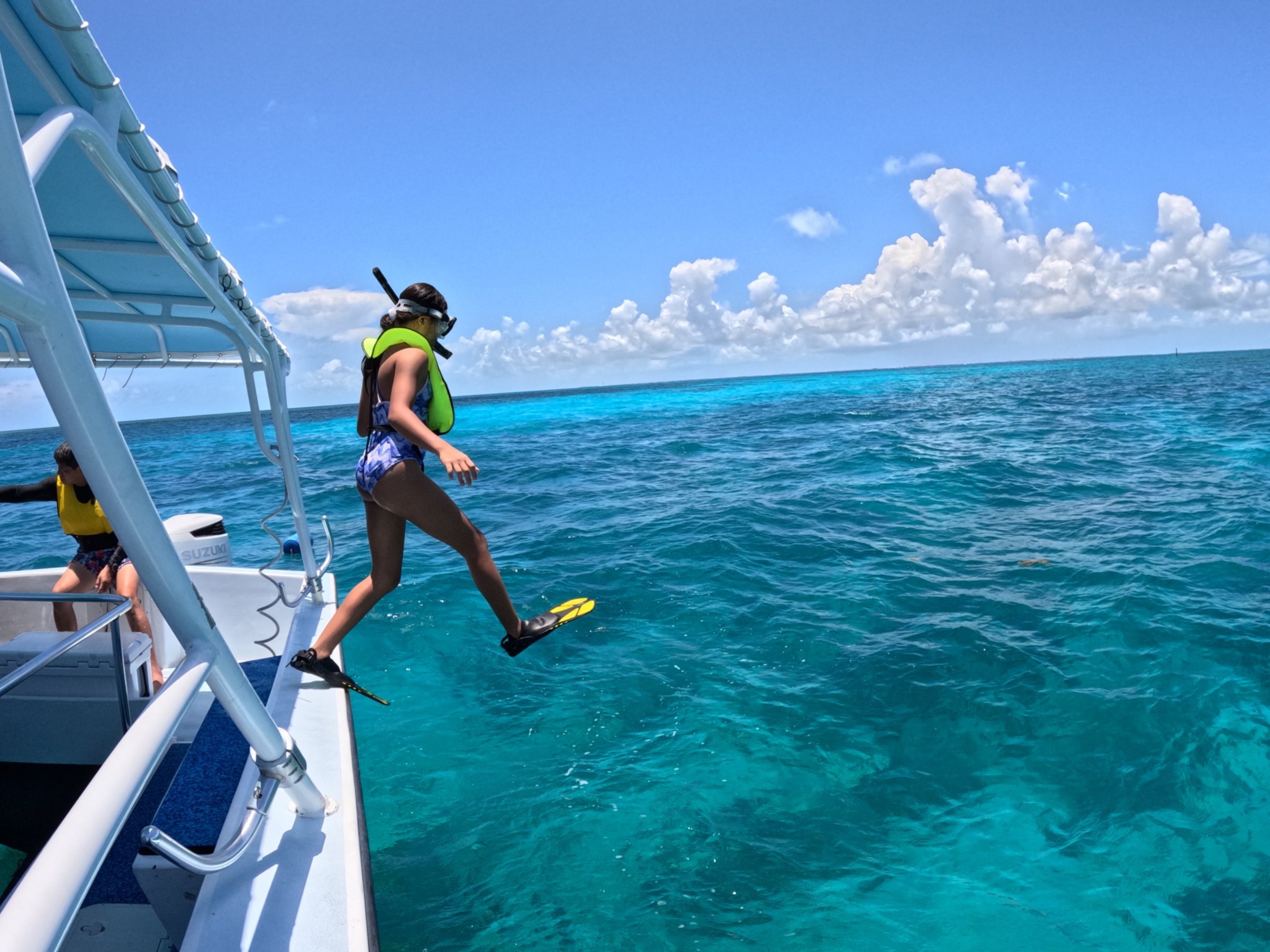 a person riding on the back of a boat in the water