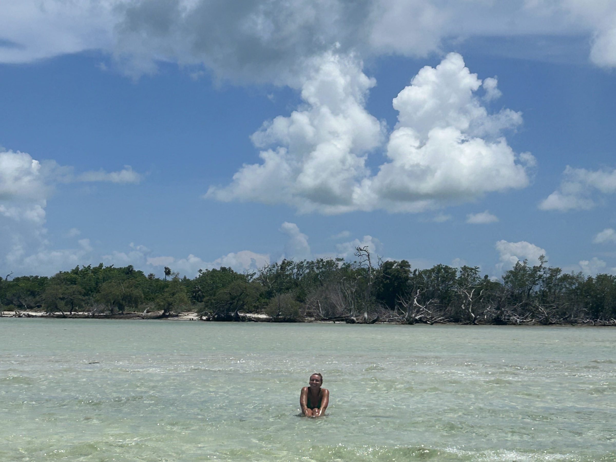 a person standing next to a body of water