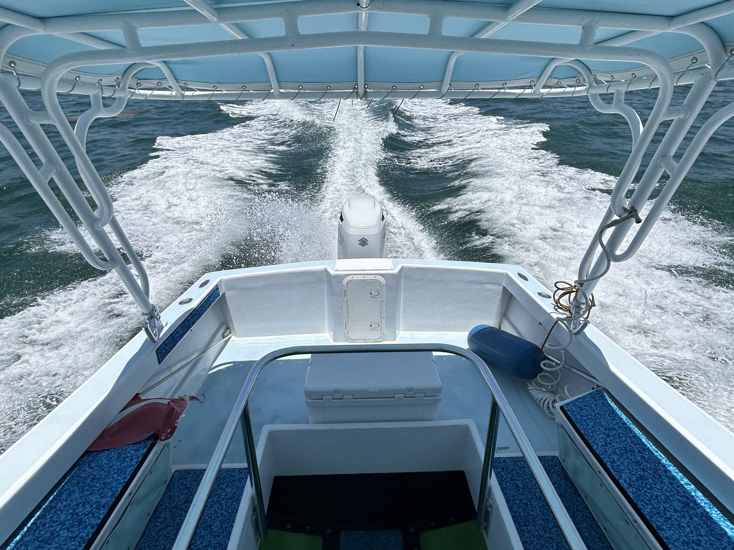 a boat sitting on top of a metal fence