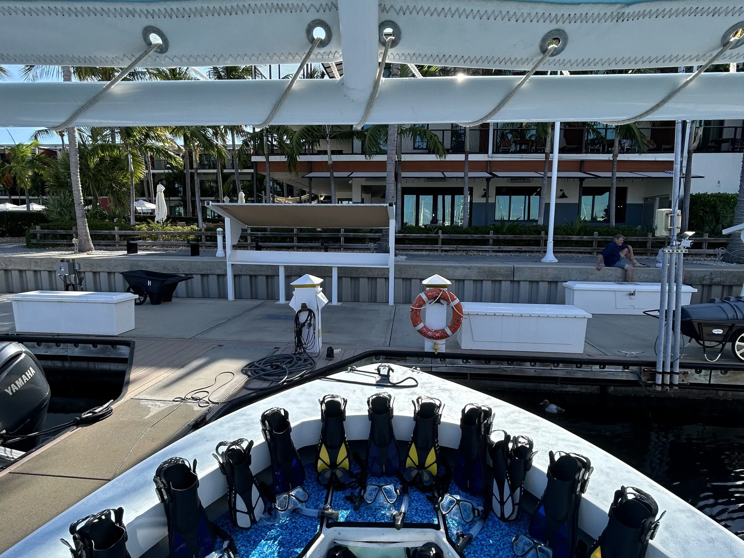 a group of people sitting in a parking lot full of snow